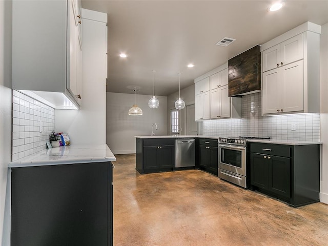 kitchen featuring recessed lighting, a peninsula, visible vents, appliances with stainless steel finishes, and pendant lighting