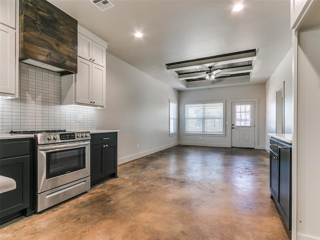 kitchen with light countertops, visible vents, a ceiling fan, stainless steel range with electric cooktop, and baseboards