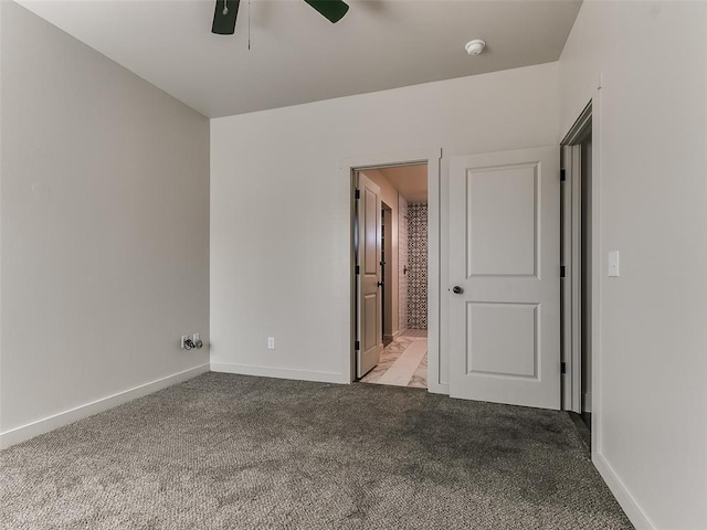 unfurnished bedroom featuring ceiling fan, ensuite bathroom, carpet flooring, and baseboards