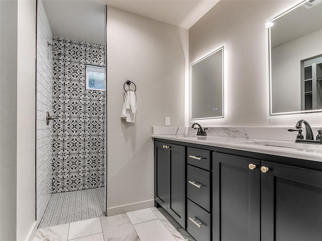 bathroom featuring double vanity, marble finish floor, walk in shower, and a sink