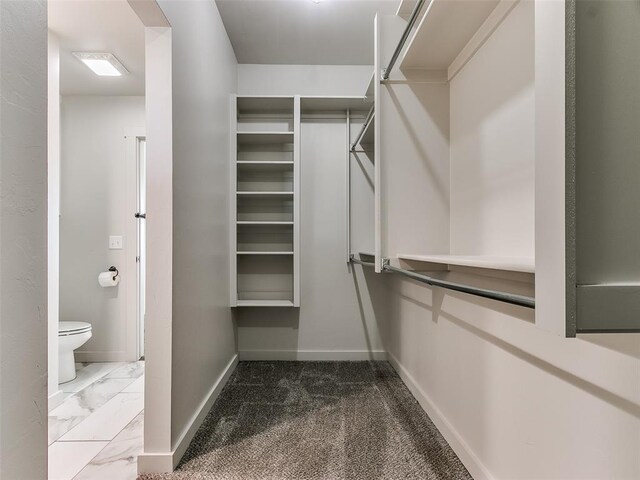 spacious closet featuring marble finish floor