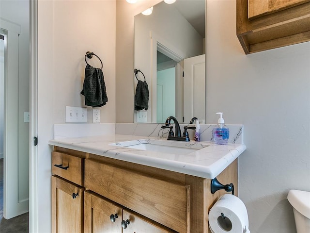 bathroom with toilet and vanity