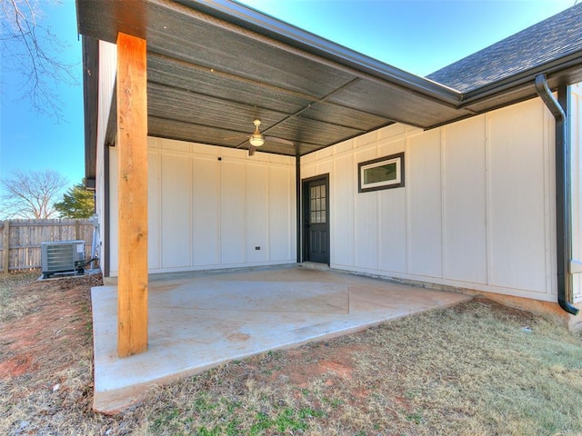 view of patio / terrace with fence, cooling unit, and a carport