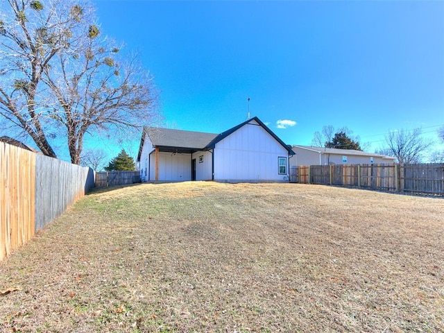 exterior space featuring a lawn and a fenced backyard