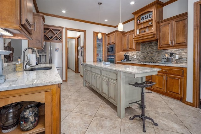 kitchen featuring stainless steel appliances, light stone counters, light tile patterned flooring, and a sink