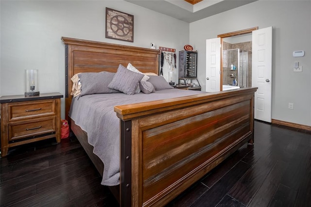 bedroom with dark wood-type flooring and baseboards