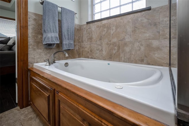 bathroom with a bath and tile patterned floors