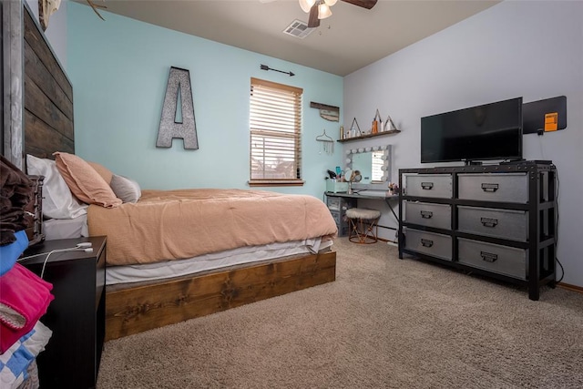 carpeted bedroom with visible vents and a ceiling fan