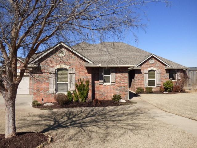 ranch-style house with roof with shingles, concrete driveway, and brick siding