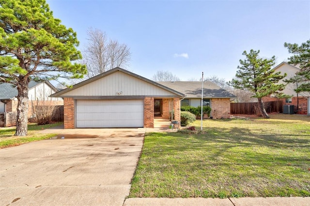 view of front of property with brick siding, fence, concrete driveway, a front yard, and a garage