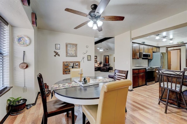 dining space featuring light wood-type flooring and ceiling fan