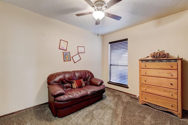 sitting room featuring a ceiling fan, carpet, and baseboards