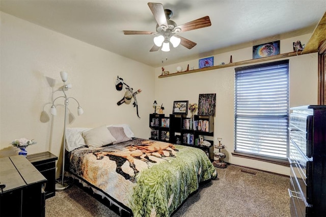 carpeted bedroom with visible vents and ceiling fan