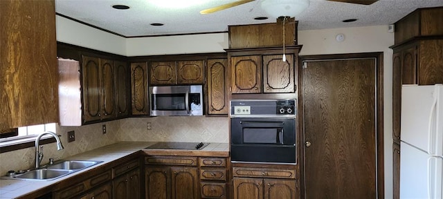 kitchen with tile counters, tasteful backsplash, a ceiling fan, a sink, and black appliances