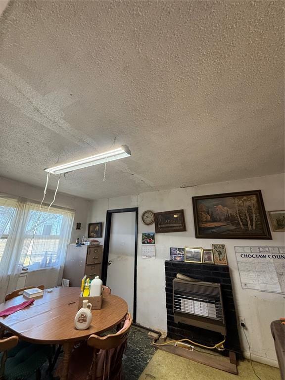 dining room with a textured ceiling and heating unit