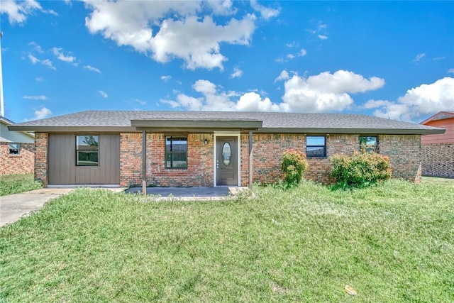 ranch-style house with a front lawn and brick siding