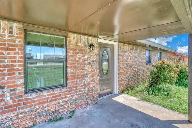 property entrance featuring brick siding