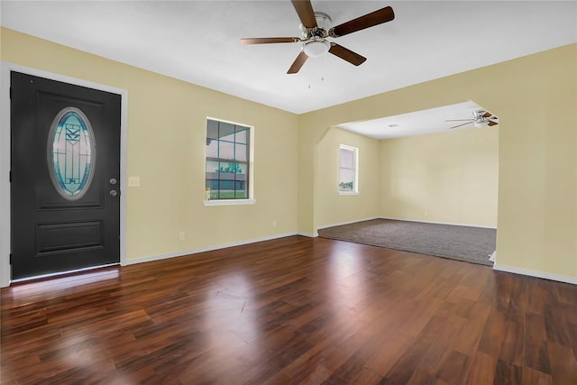 foyer with ceiling fan, baseboards, and wood finished floors