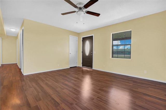 empty room featuring ceiling fan, baseboards, and wood finished floors