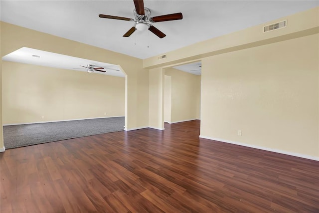 unfurnished room featuring visible vents, ceiling fan, baseboards, and wood finished floors