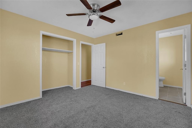 unfurnished bedroom featuring carpet, visible vents, and baseboards