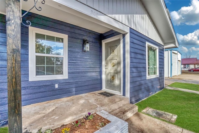 view of exterior entry featuring covered porch