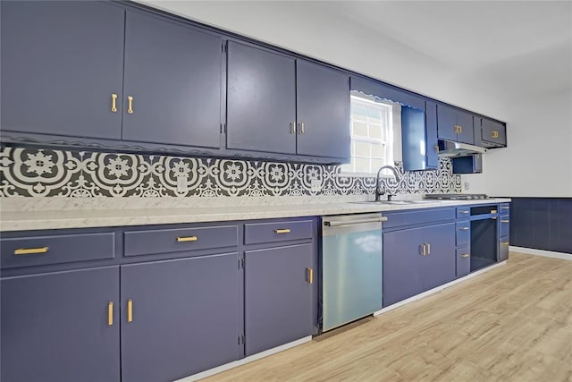 kitchen featuring blue cabinetry, light wood-style floors, dishwasher, and light countertops