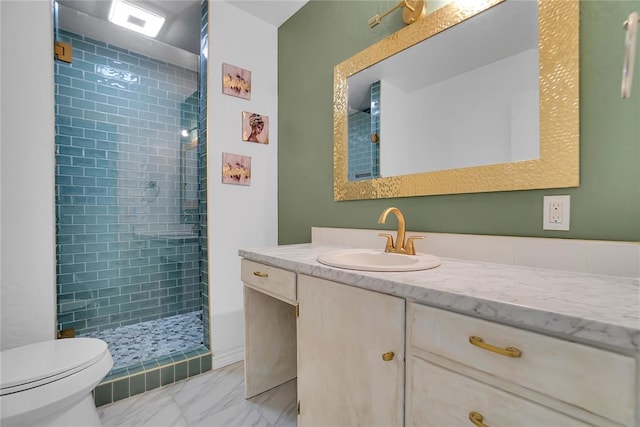 bathroom with toilet, marble finish floor, a shower stall, and vanity