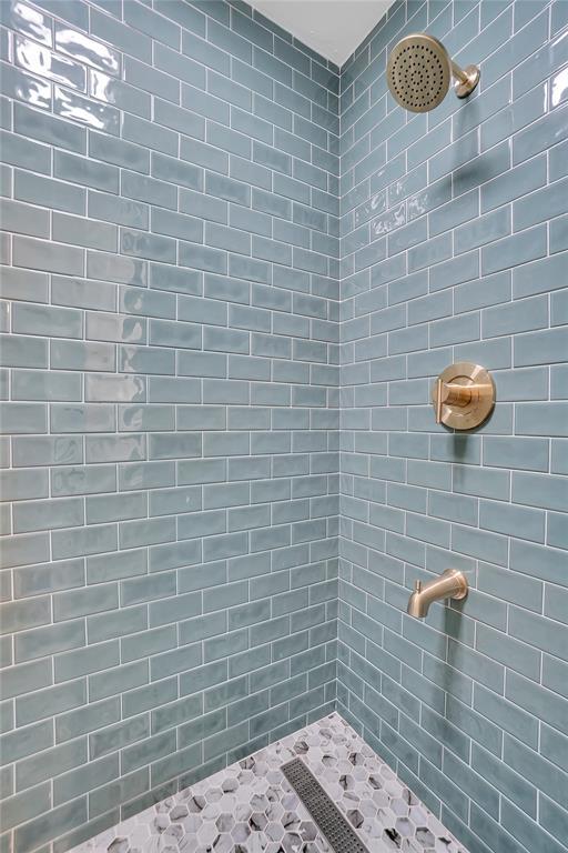 full bathroom with tiled shower