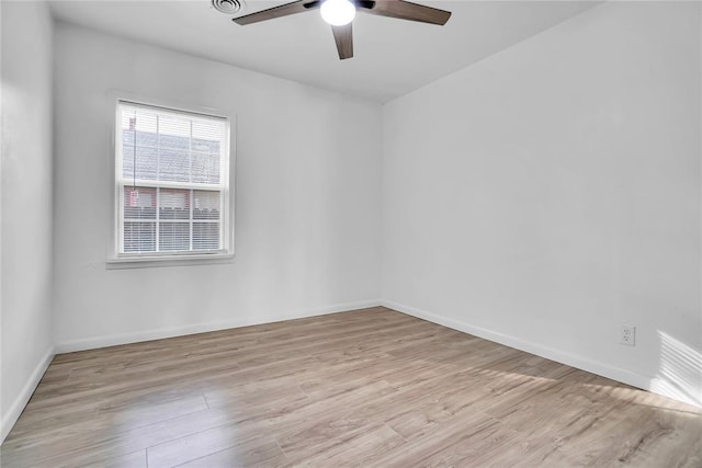 unfurnished room with baseboards, ceiling fan, and light wood finished floors