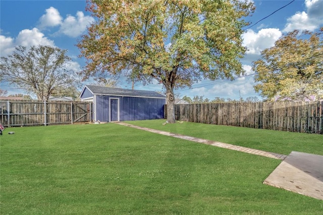 view of yard with a fenced backyard and an outbuilding