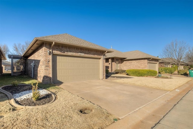 view of front of property with a garage, brick siding, driveway, and a shingled roof