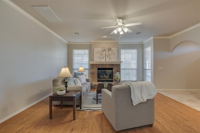 living area with wood finished floors, visible vents, and baseboards