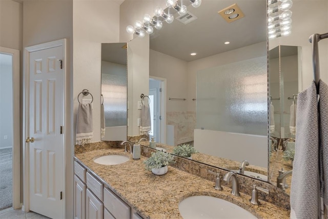 full bathroom with double vanity, recessed lighting, visible vents, and a sink