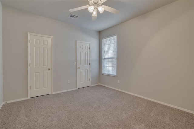 unfurnished bedroom featuring visible vents, baseboards, carpet, and ceiling fan