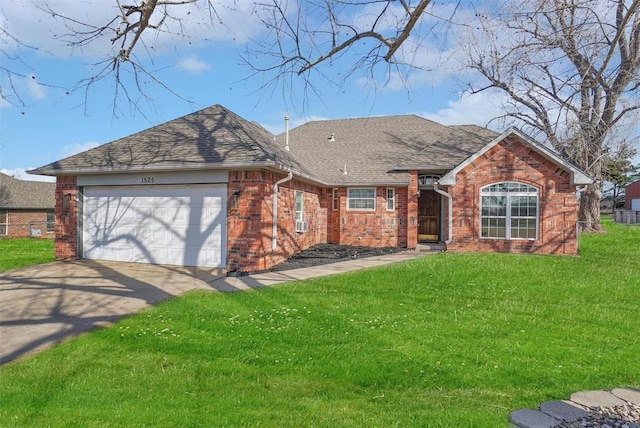 single story home featuring a garage, a front yard, concrete driveway, and brick siding