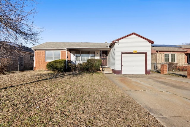 ranch-style house with concrete driveway, a porch, an attached garage, a front lawn, and brick siding