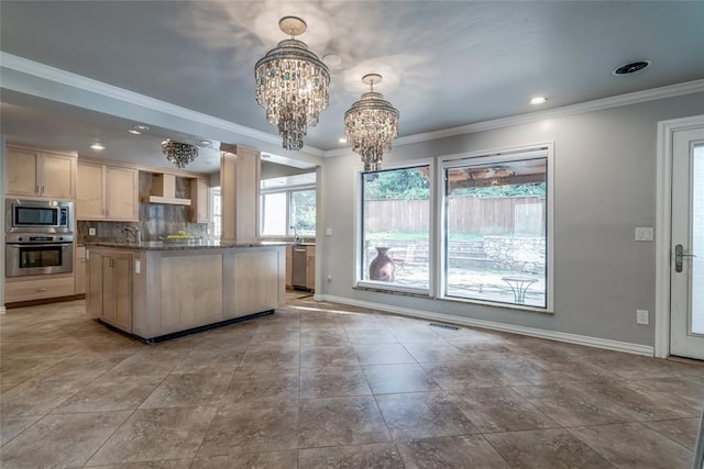 kitchen featuring decorative backsplash, wall chimney exhaust hood, stainless steel appliances, crown molding, and a notable chandelier