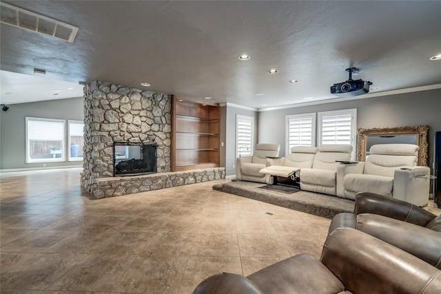 living room with lofted ceiling, a stone fireplace, recessed lighting, visible vents, and crown molding