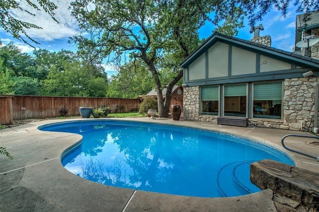 view of swimming pool featuring a fenced in pool, a fenced backyard, and a patio