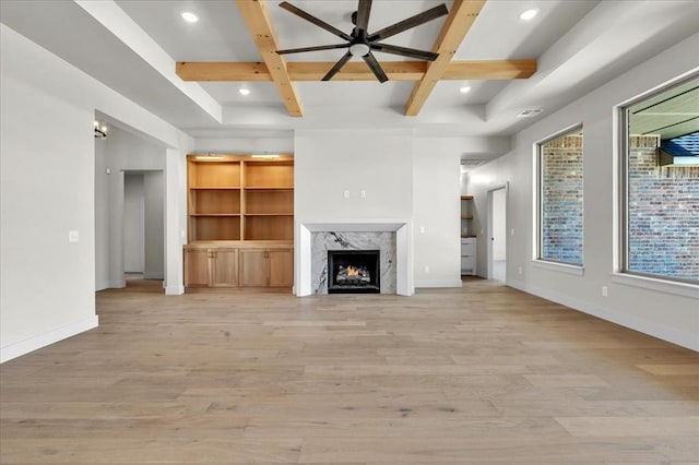 unfurnished living room featuring light wood-style floors, a fireplace, baseboards, and coffered ceiling