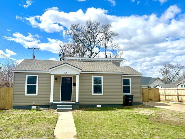 bungalow-style house with roof with shingles, crawl space, a front yard, and fence