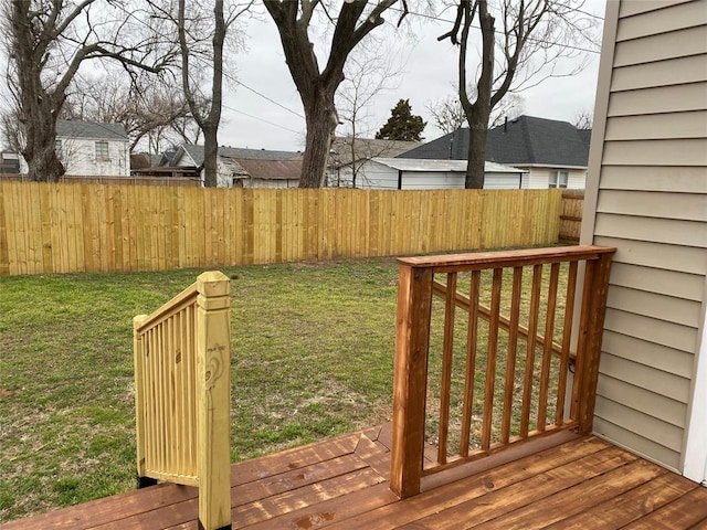 wooden deck featuring fence and a lawn