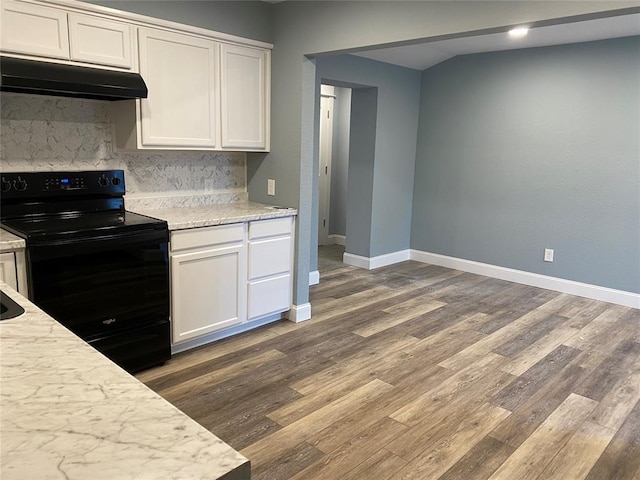 kitchen featuring white cabinets, black electric range oven, wood finished floors, light countertops, and under cabinet range hood