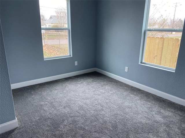 spare room with carpet flooring and baseboards