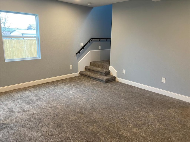 basement featuring stairs, carpet flooring, and baseboards