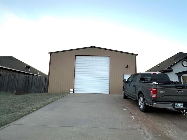 detached garage featuring fence