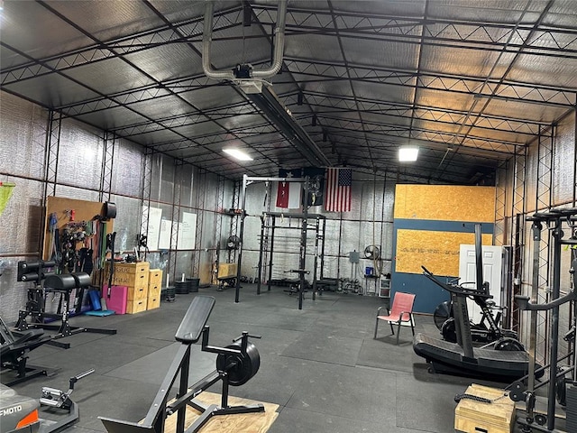 exercise room featuring a garage and a towering ceiling