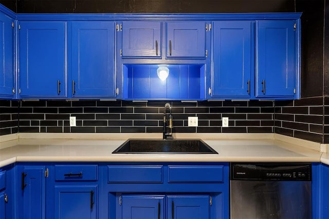 kitchen featuring dishwasher, light countertops, a sink, and blue cabinets