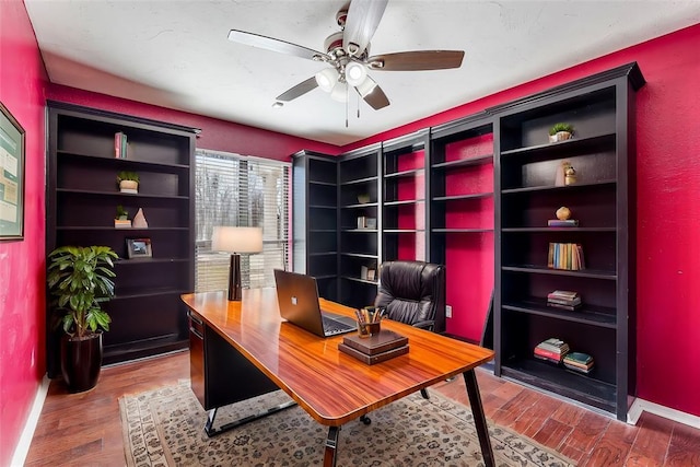 office space with ceiling fan, baseboards, and wood finished floors